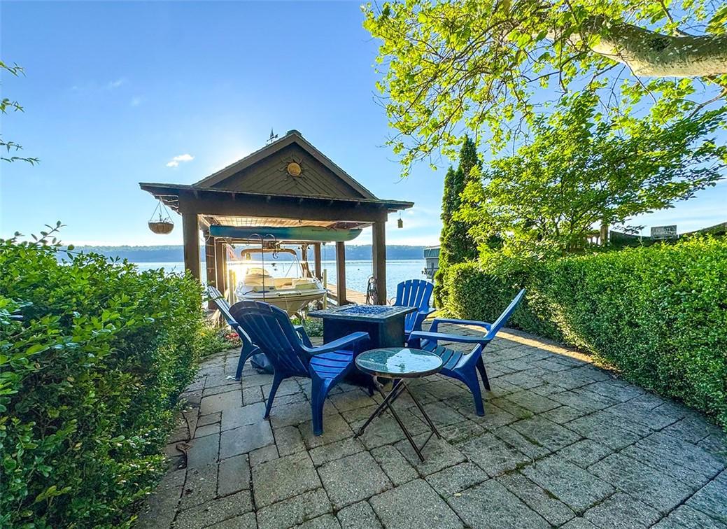Image 3: Landscaped Patio and Fire Pit at Lakefront