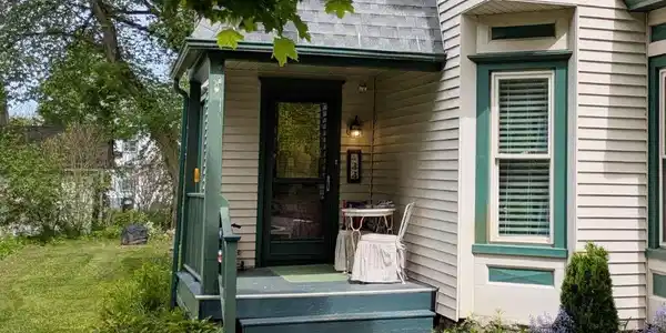 Image 2: The covered front porch with room for a table and