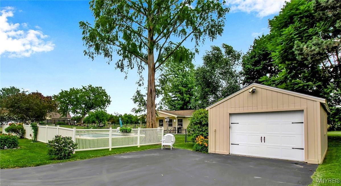 Image 3: Fenced in pool area and detached garage with addit