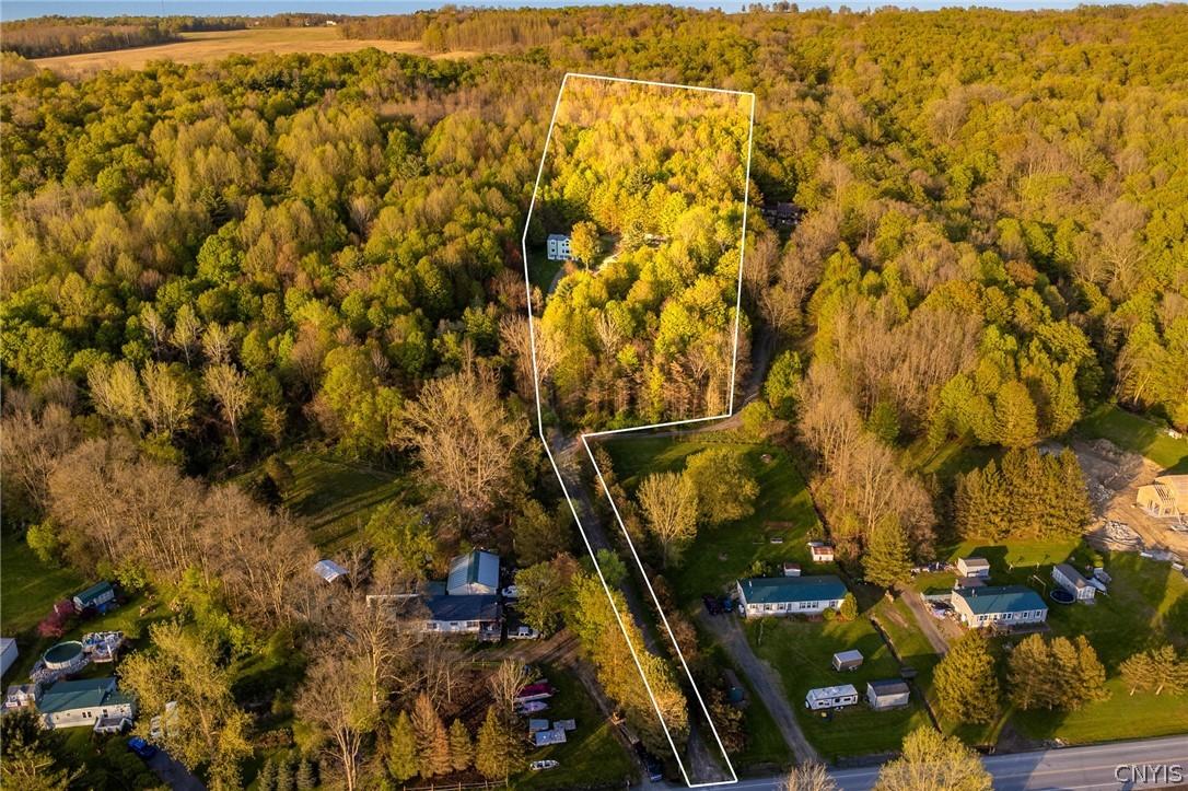 Image 2: The home is in a private setting, perched on a hil