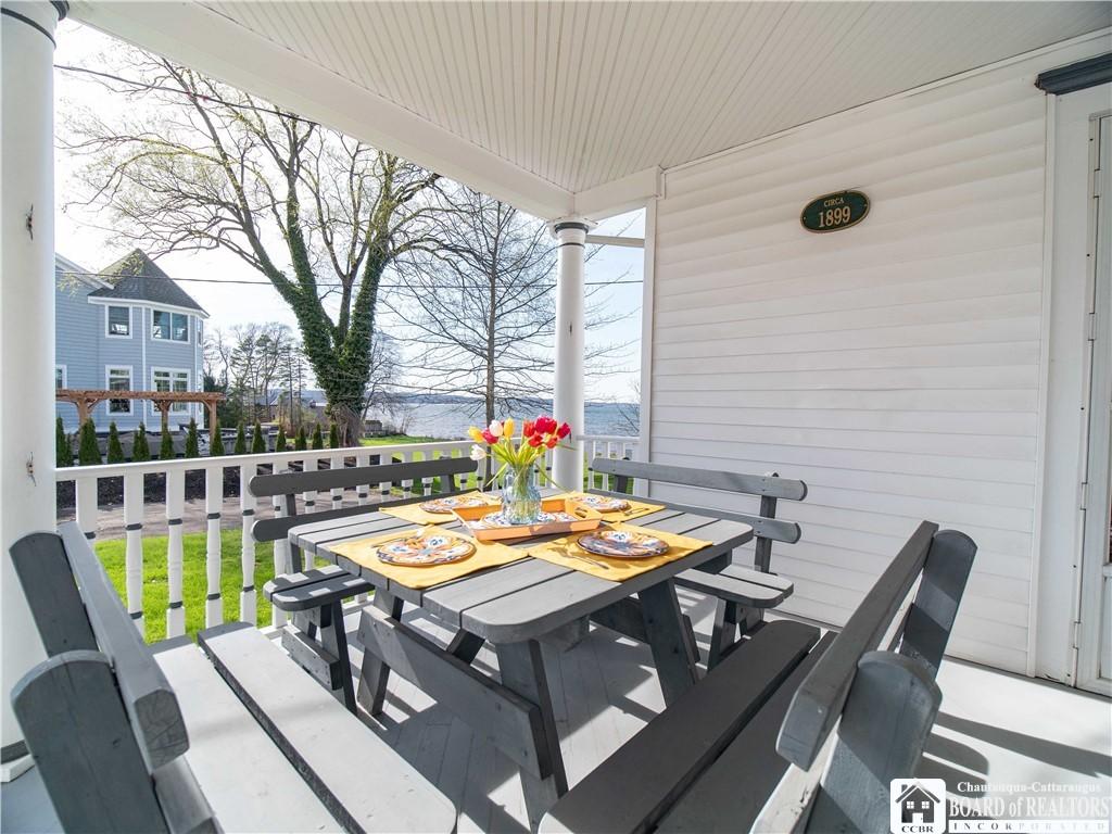 Image 4: Al fresco dining on the covered porch offers delig