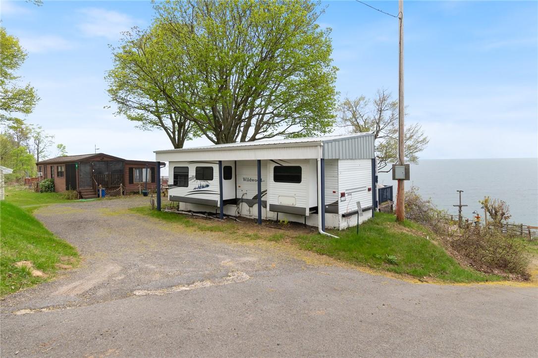 Image 4: The stone/gravel parking areas at 7945 LAKE RD #85