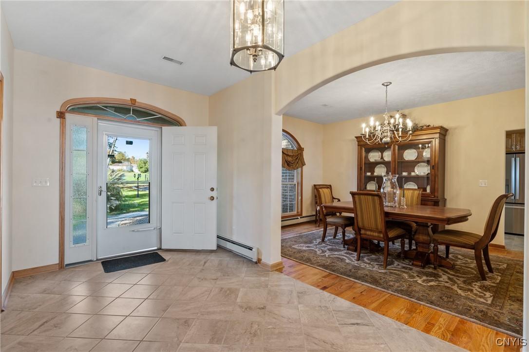 Image 4: The sizeable foyer is dramatic and convenient for
