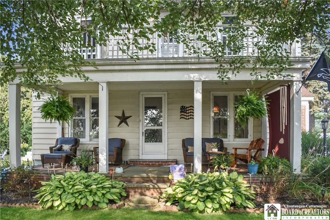 Image 1: Covered side porch facing Ellery Park.