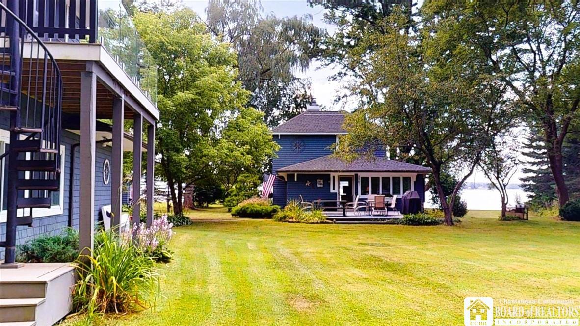 Image 4: Side yard and Spiral staircase to cozy guest house