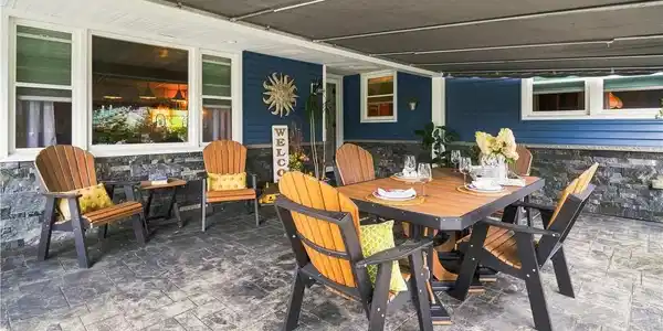 Image 4: Dining al-fresco beneath the awning is the perfect