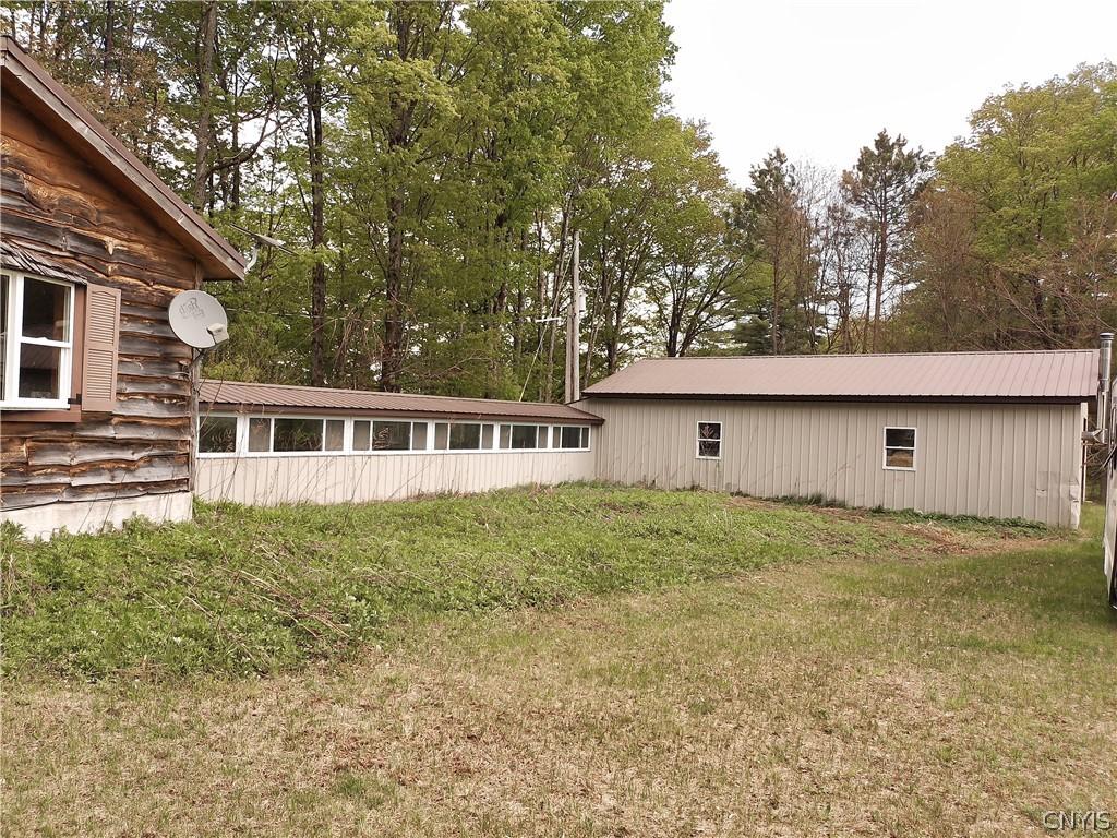 Image 3: Long enclosed breezeway connects garage to cabin