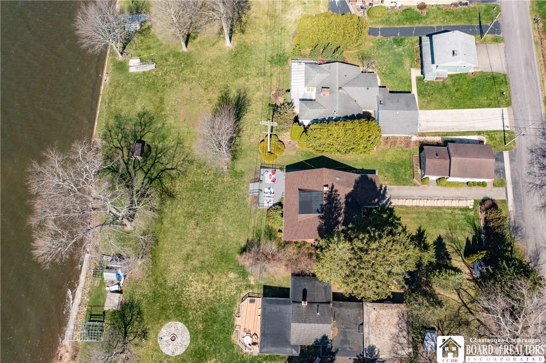 Image 3: Nestled on a quiet lakeside street, this home offe