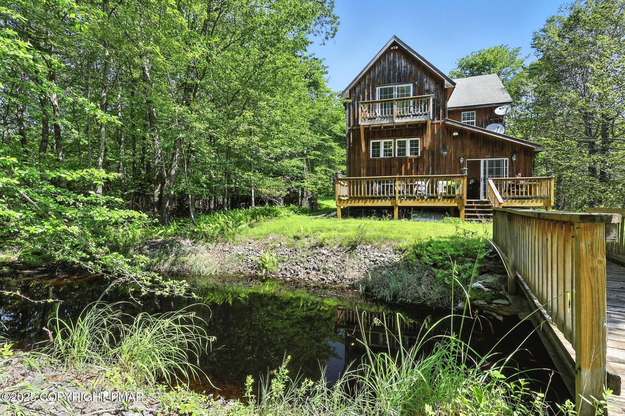 Image 3: back view of house with pond