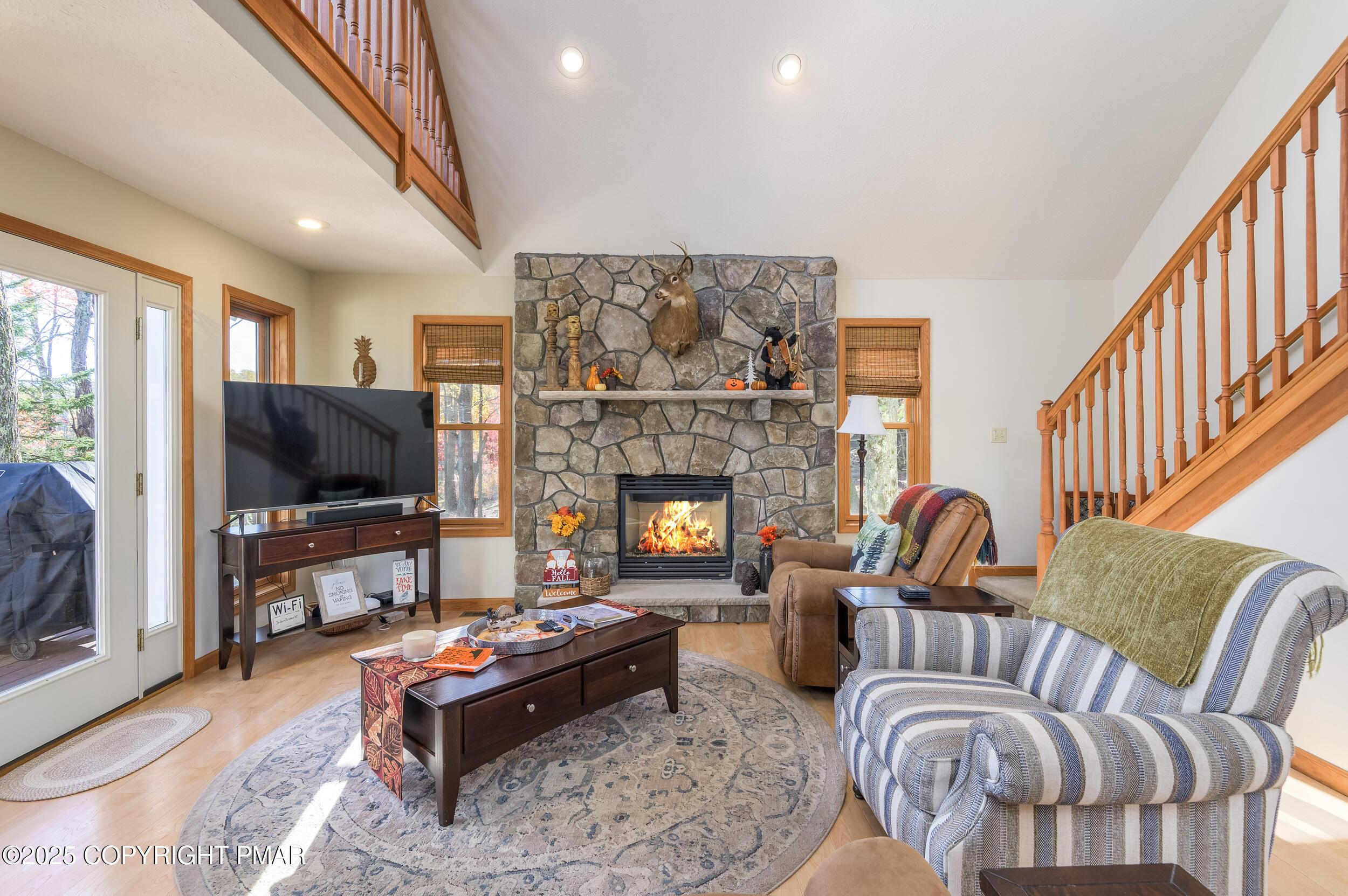 Image 4: Living room with stone faced propane fir