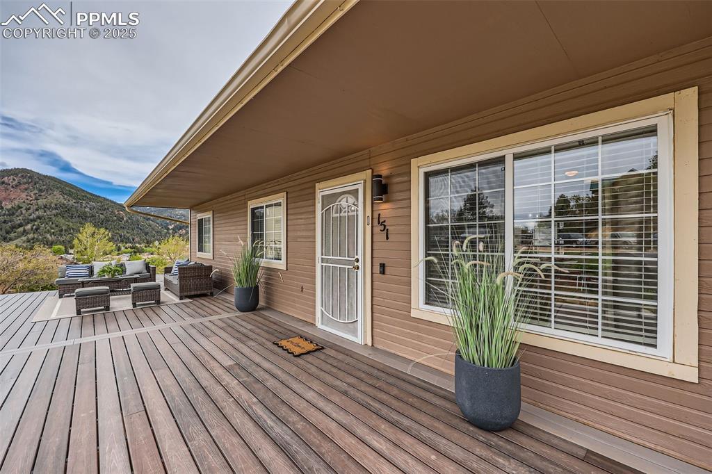 Image 3: Wooden terrace featuring an outdoor hangout area and a mountain view