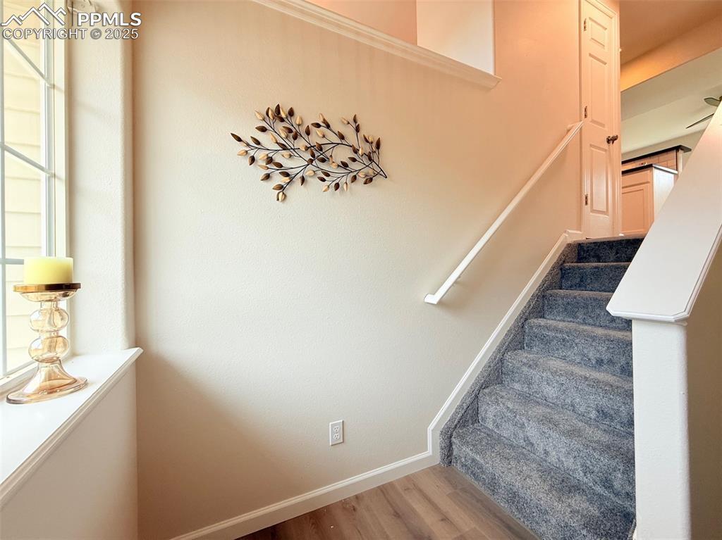 Image 4: Staircase with baseboards and wood finished floors