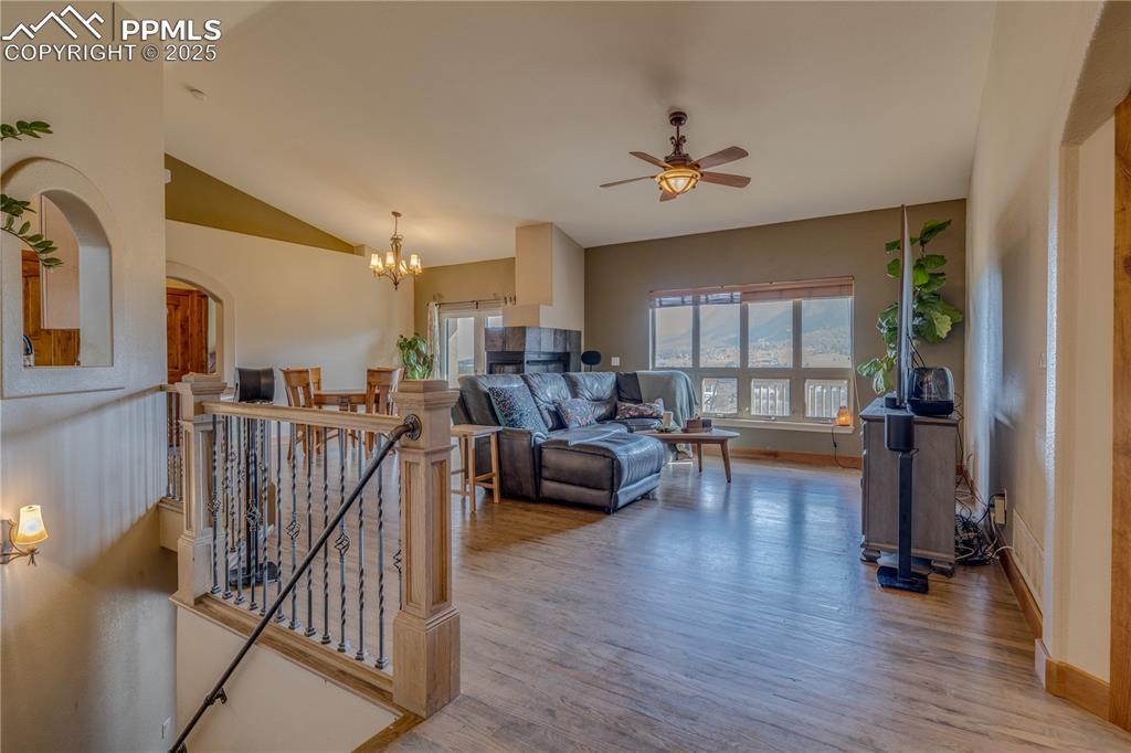 Image 2: Living area featuring lofted ceiling, wood finished floors, abundant natural light, walk out to deck.