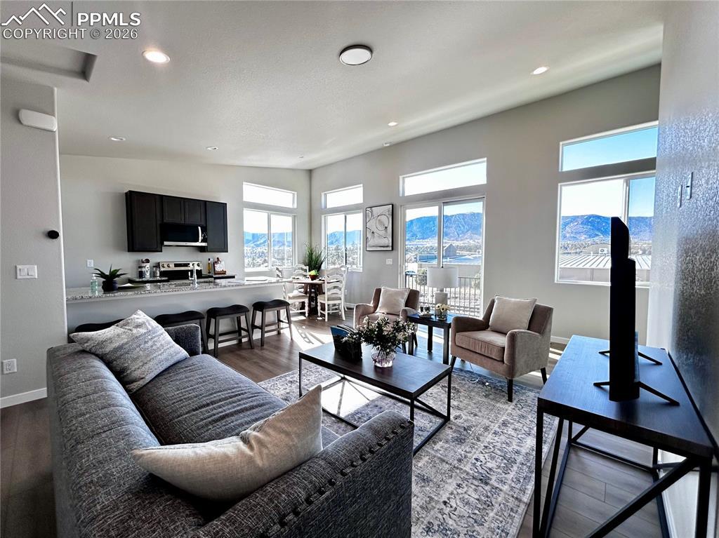 Image 4: Living room featuring dark wood-type flooring and recessed lighting