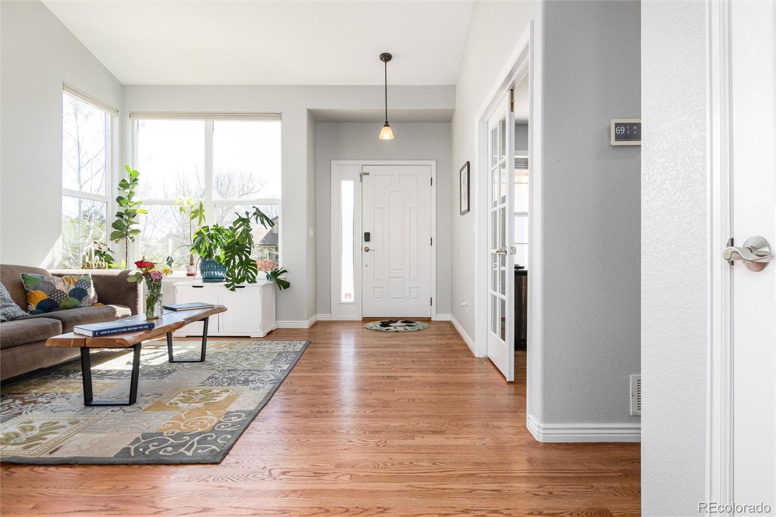 Image 4: Inside you are greeted by a living room with vaulted ceilings and lots of natural light