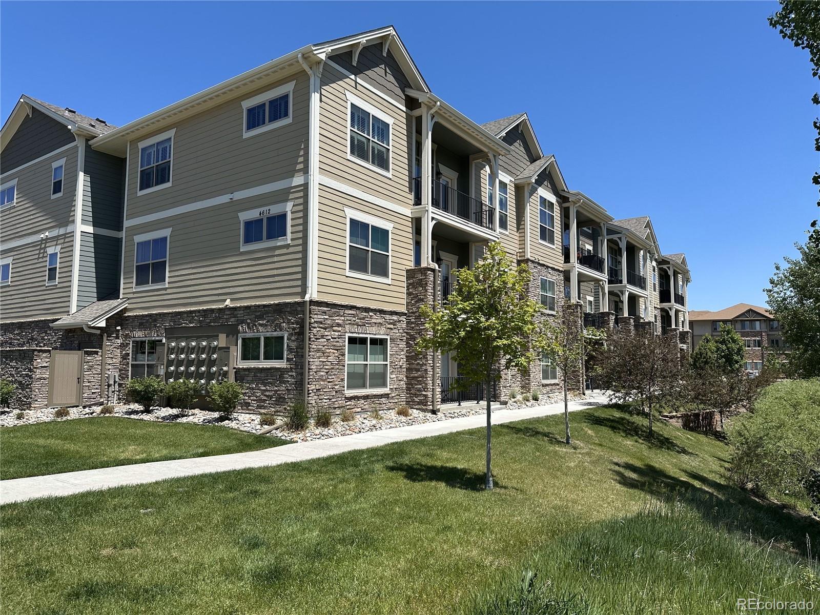 Image 2: 2nd view of Building at The Flats at Centerra. Ground Level Unit #102 Unit faces Open Space Area