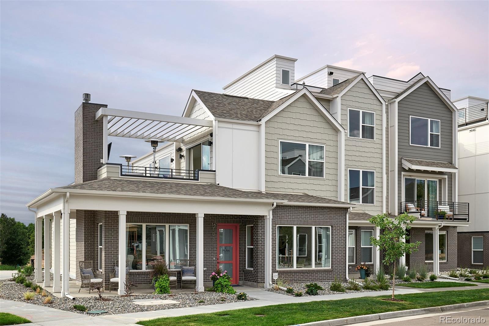 Image 1: Two-level townhome w/wrap around front porch, main floor primary