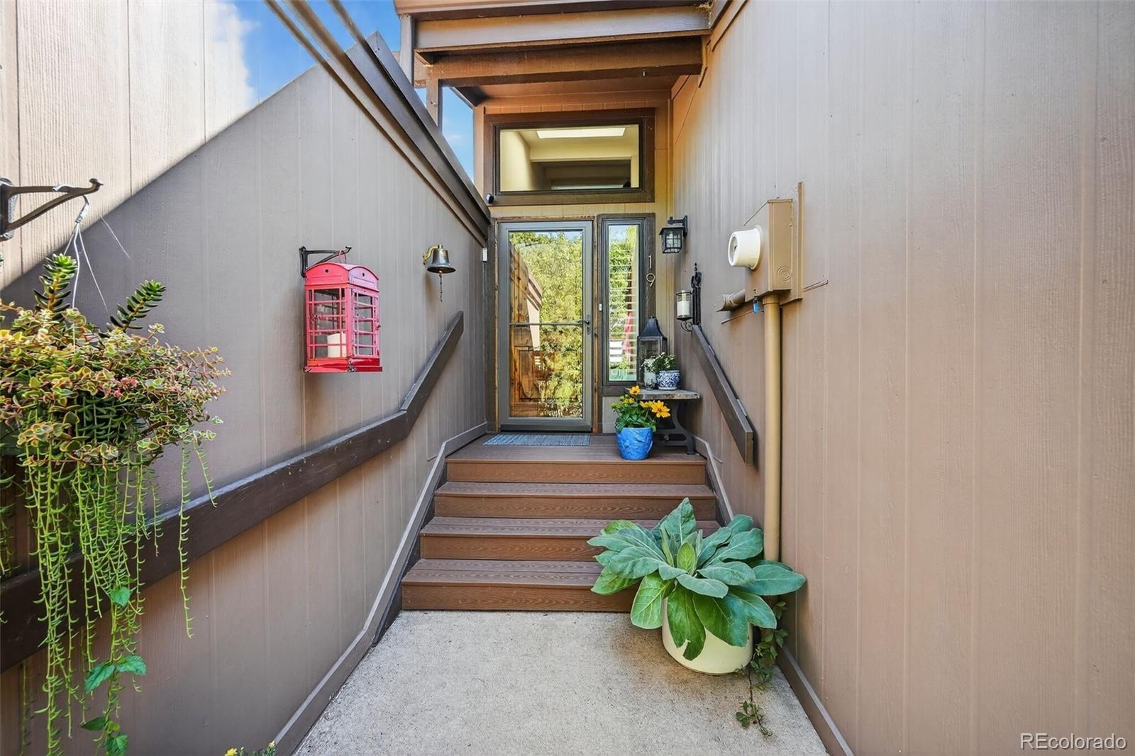 Image 4: The covered entry has refurbished stairs and a custom built Alder front door.