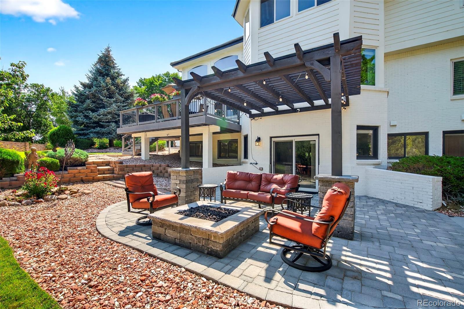 Image 1: Custom fire pit, pergola and stone patio offers the perfect place to unwind. Image 1: Custom fire pit, pergola and stone patio offers the perfect place to unwind.