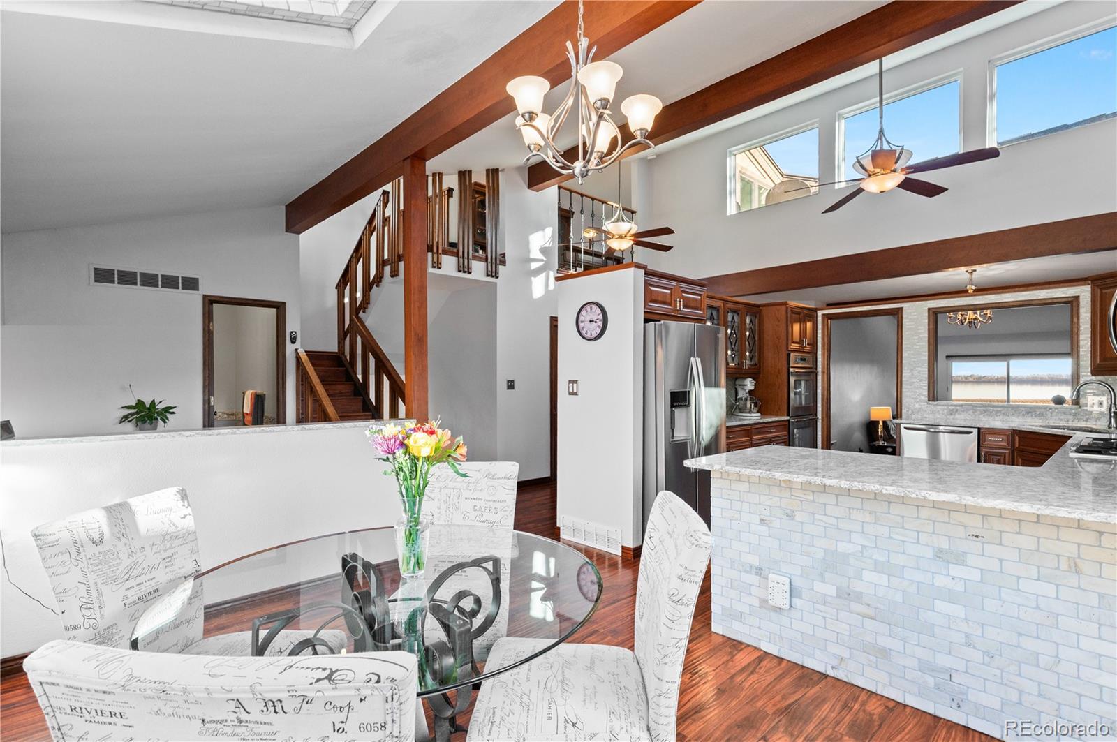 Image 2: Main-level breakfast nook and dining area Main-level breakfast nook and dining area with vaulted ceilings and abundant natural light.