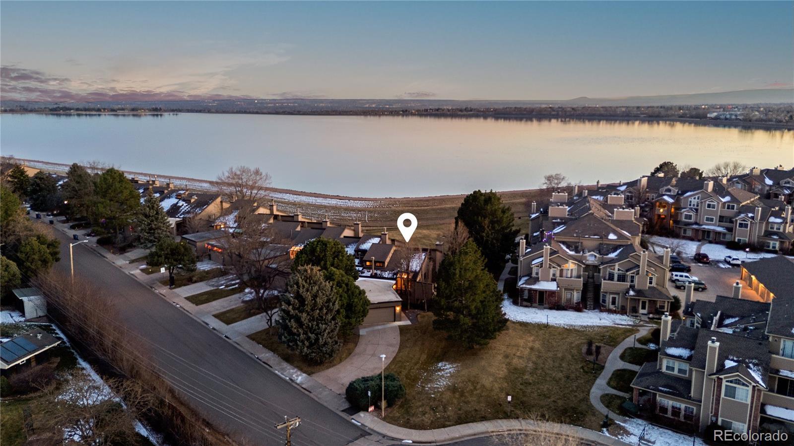 Image 3: Aerial view showcasing location by lake Aerial view highlighting the home&rsquo;s location adjacent to Marston Lake.