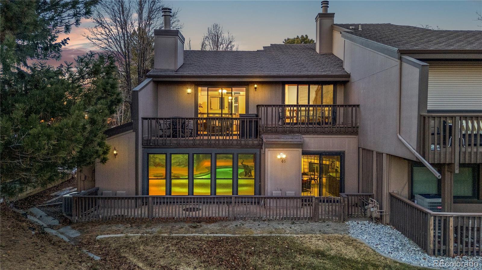 Image 4: Rear exterior Rear exterior showing the walk-out lower level and multiple decks.