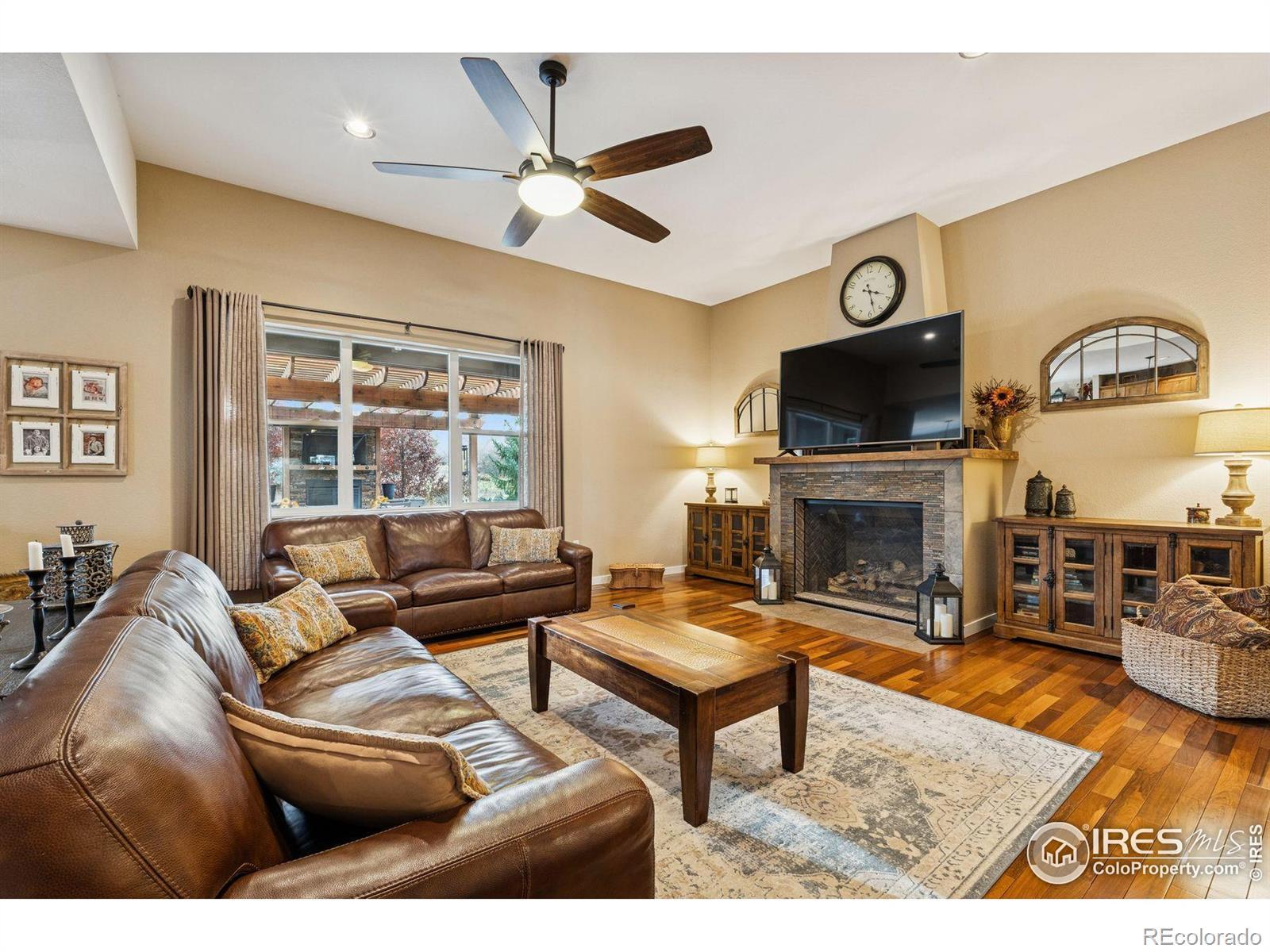 Image 4: An elegant main level features rich Brazilian walnut floors and a fireplace that creates warmth and ambiance.