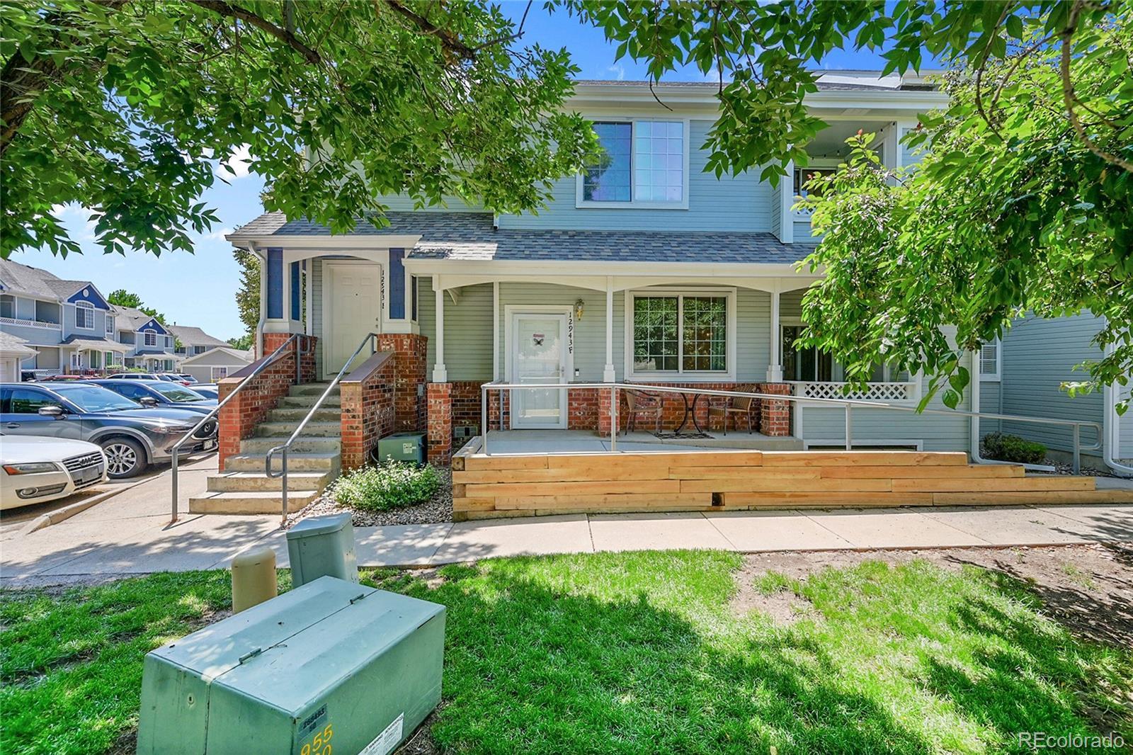 Image 3: Unit is in center of photo. Sitting area on Front Porch, patio offers storage closet