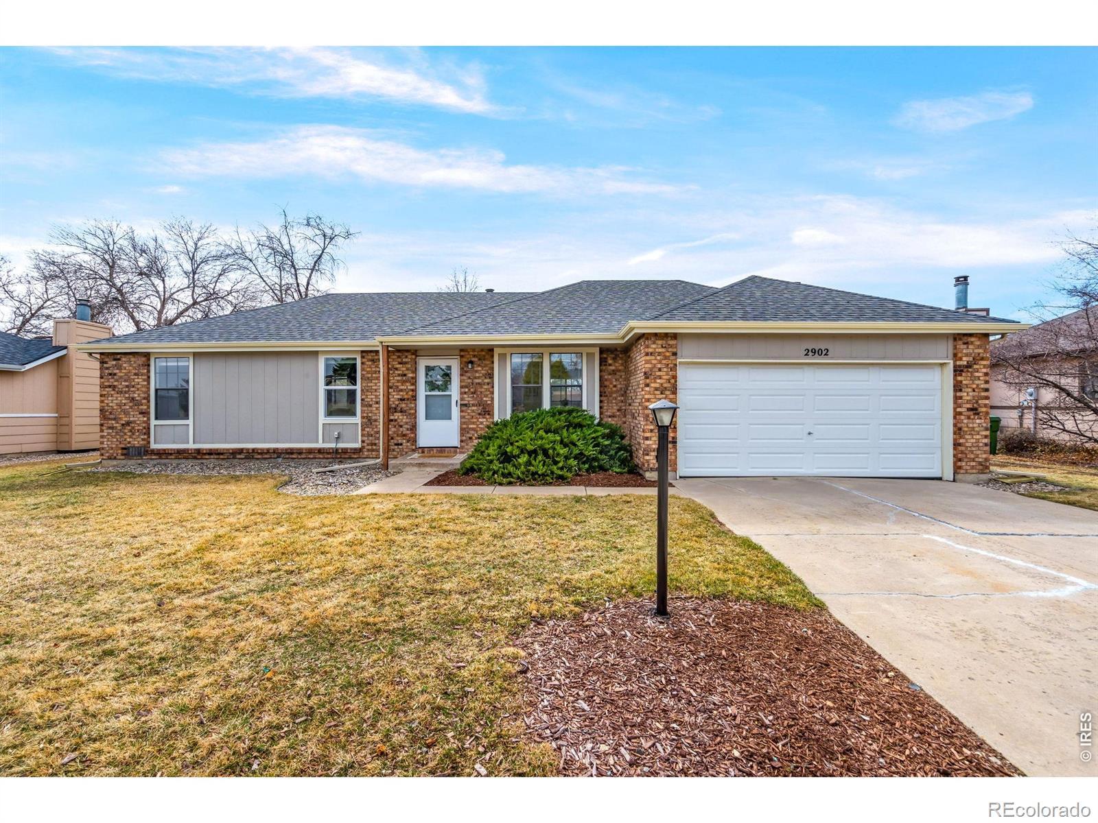 Image 1: Charming brick ranch with a two-car garage and welcoming curb appeal.
