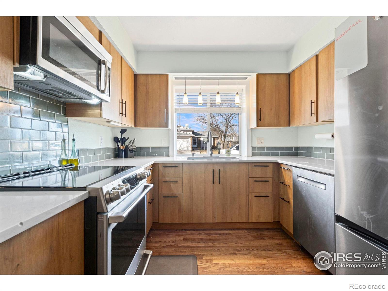 Image 4: Quartz countertops, updated Euro style, soft close cabinets, Stainless steel appliances, Blanco sink, glass tile backsplash Image 4: Quartz countertops, updated Euro style, soft close cabinets, Stainless steel appliances, Blanco sink, glass tile backsplash