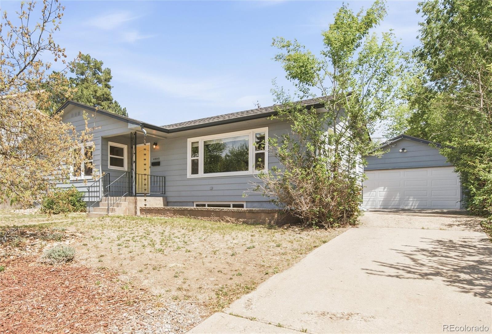 Image 2: How cute is this house? Xeriscaping and a yellow door! Two car garage down the driveway. Room for SO MANY cars!