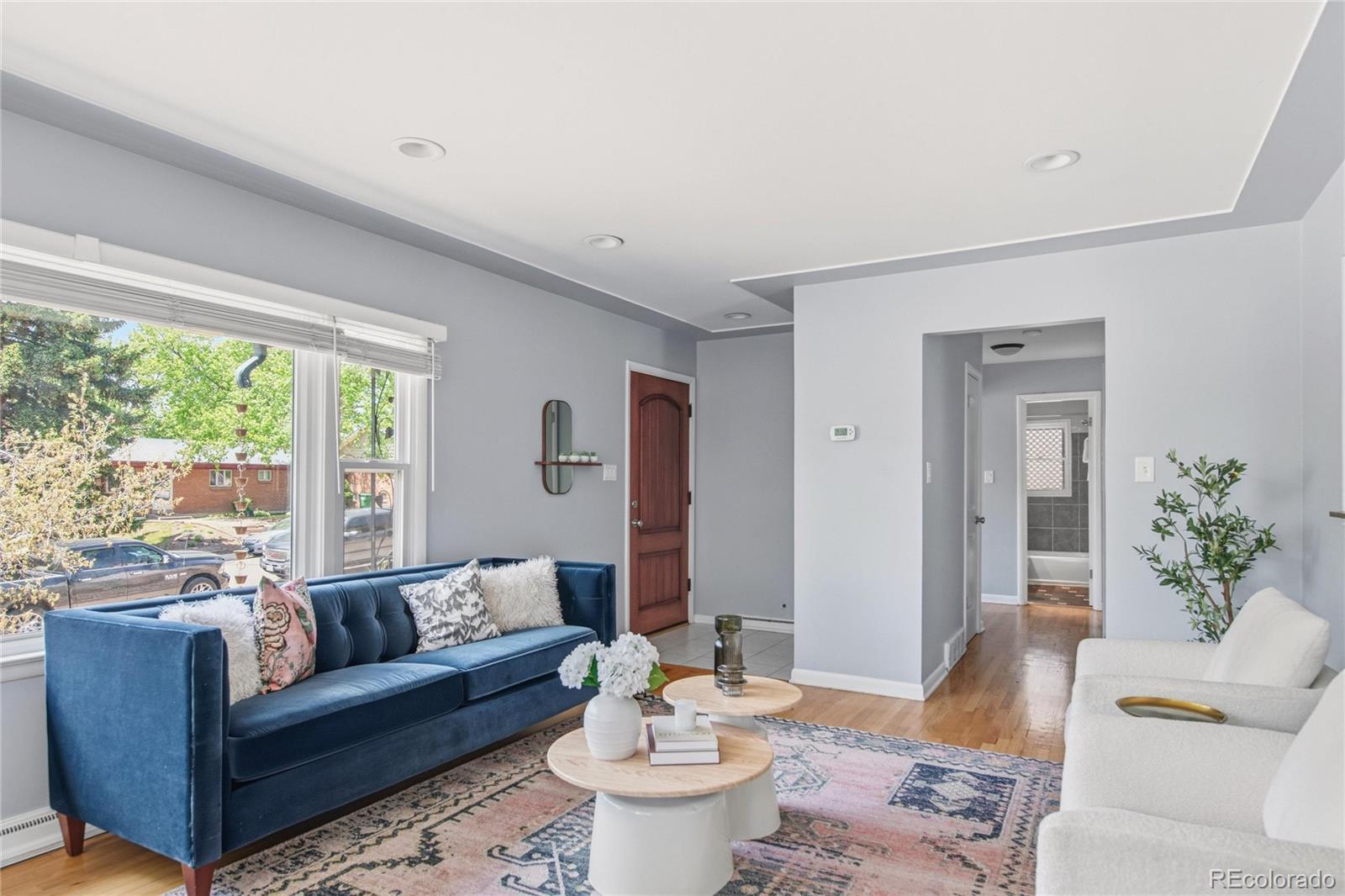 Image 3: The living room opens to the kitchen and dining area