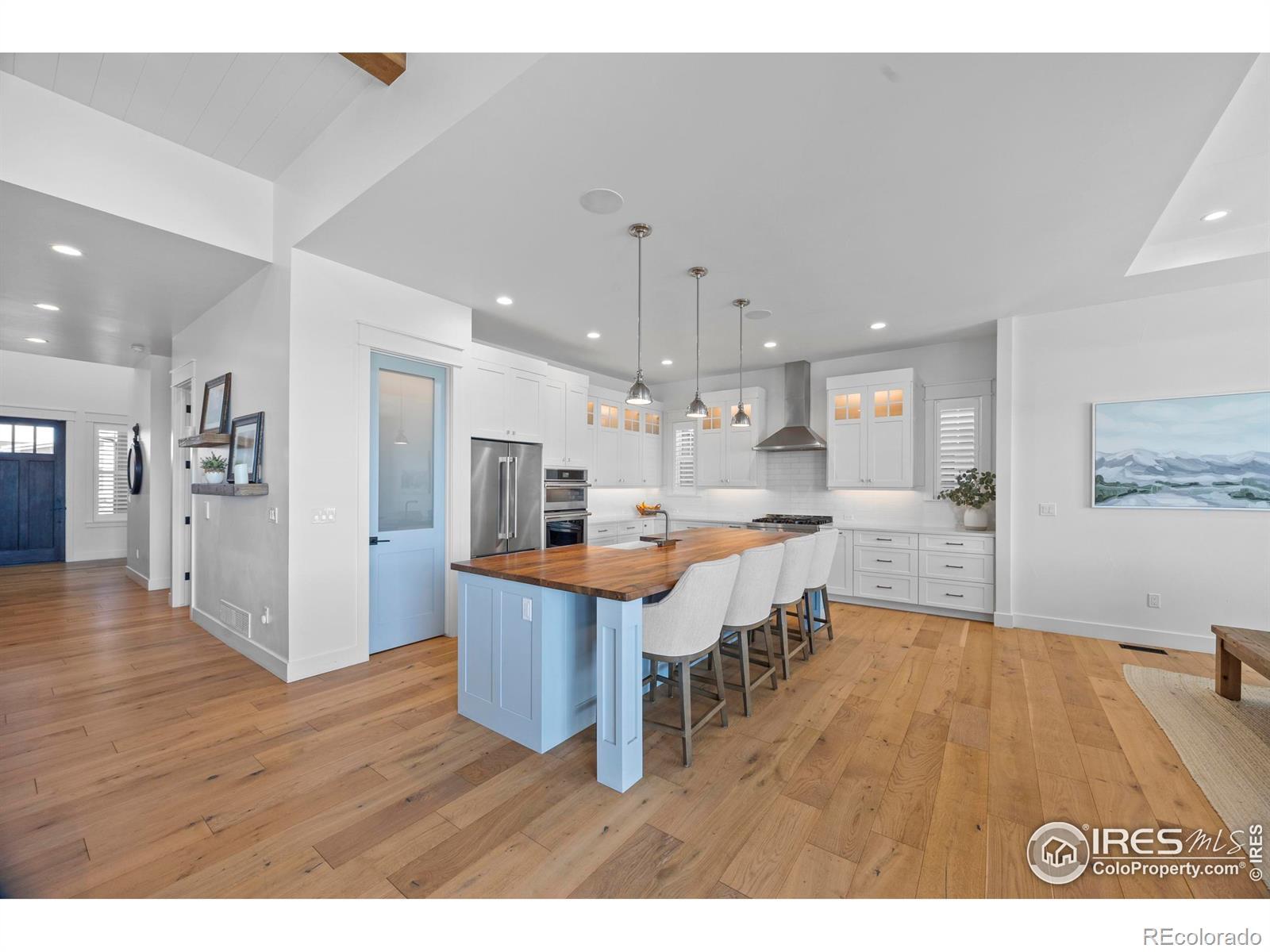 Image 4: Luxurious kitchen with large island, pantry, and stainless steel appliances