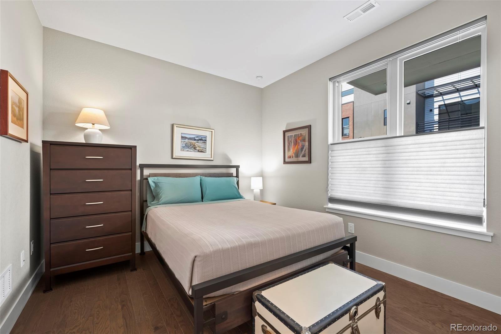 Image 3: 1st floor bedroom with ensuite bath is the perfect guest suite, home office or workout space
