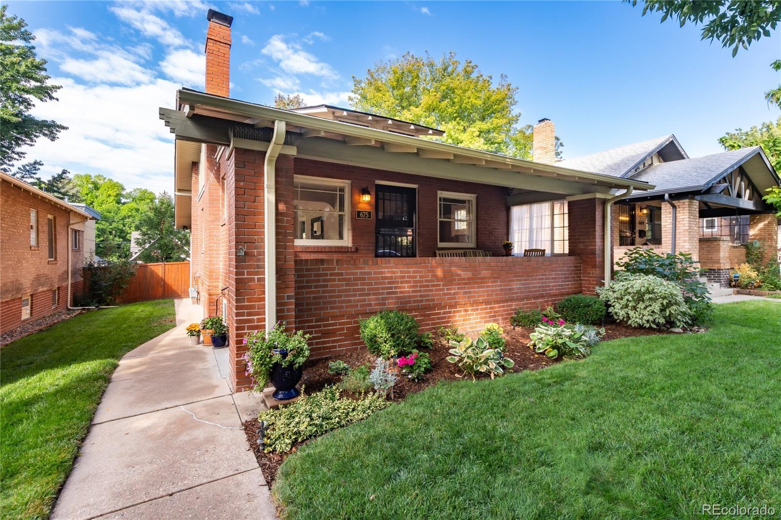 Image 2: Charming curb appeal with a big covered front porch overlooking the perfectly manicured front yard.