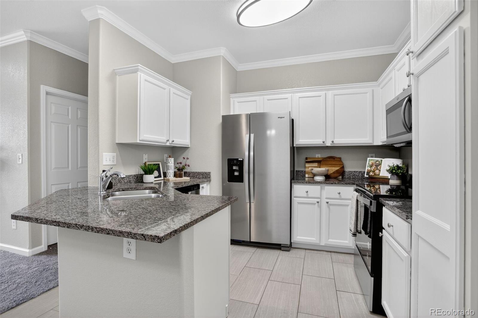 Image 4: Slab granite countertops and newly painted cabinets and walls
