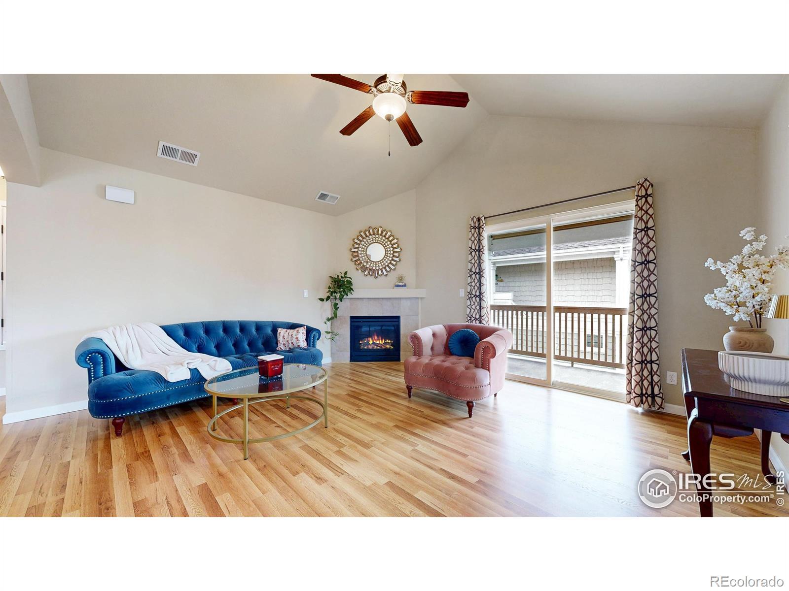 Image 2: Spacious Living Room with Fireplace and Balcony