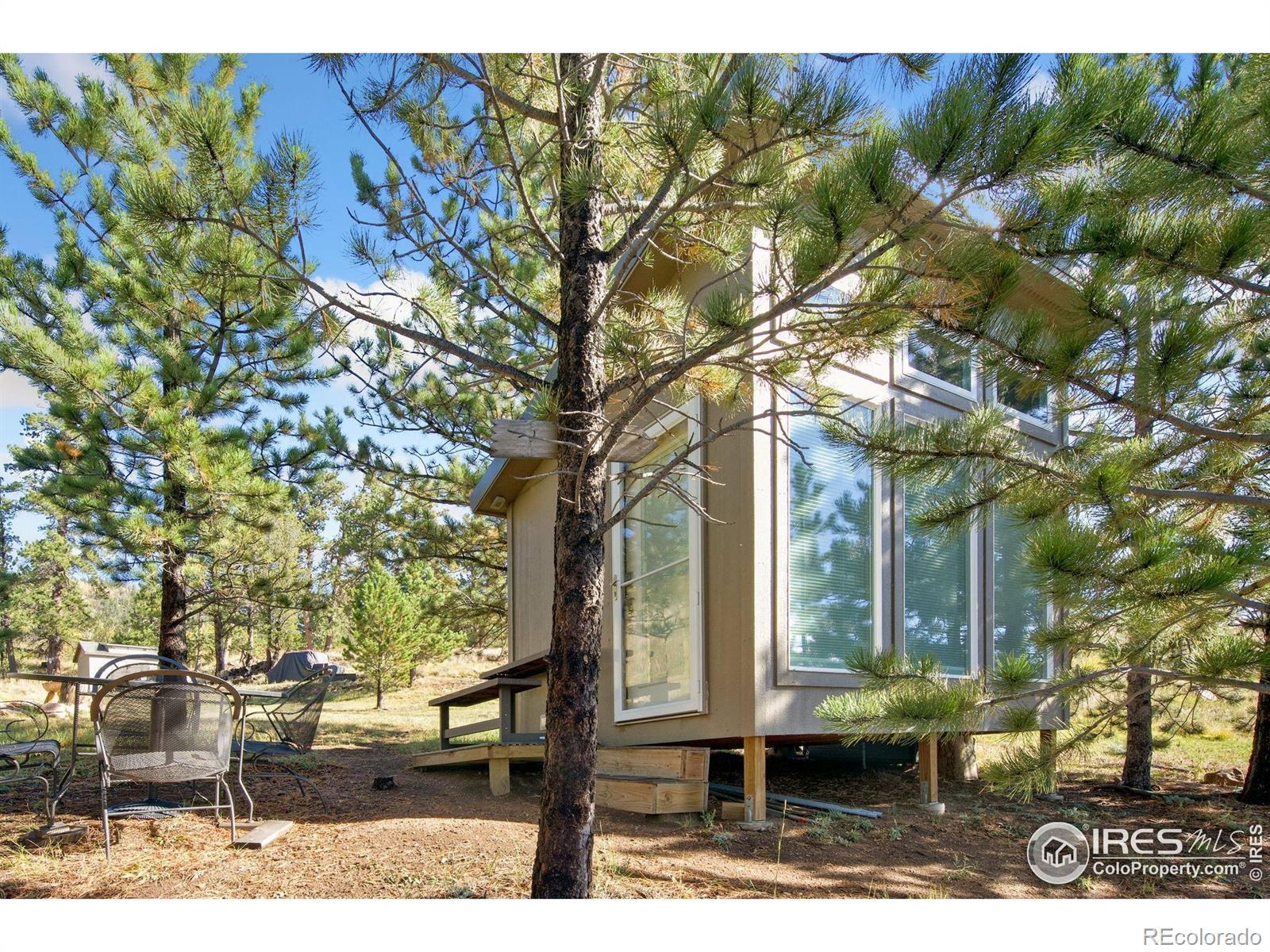 Image 3: Lower shed is nestled in the trees close to the shoreline.