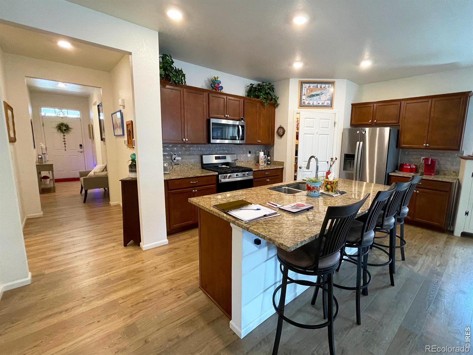 Image 4: An exceptional kitchen with energy-efficient, high-end appliances and upscale granite counters, and a convenient, large pantry.