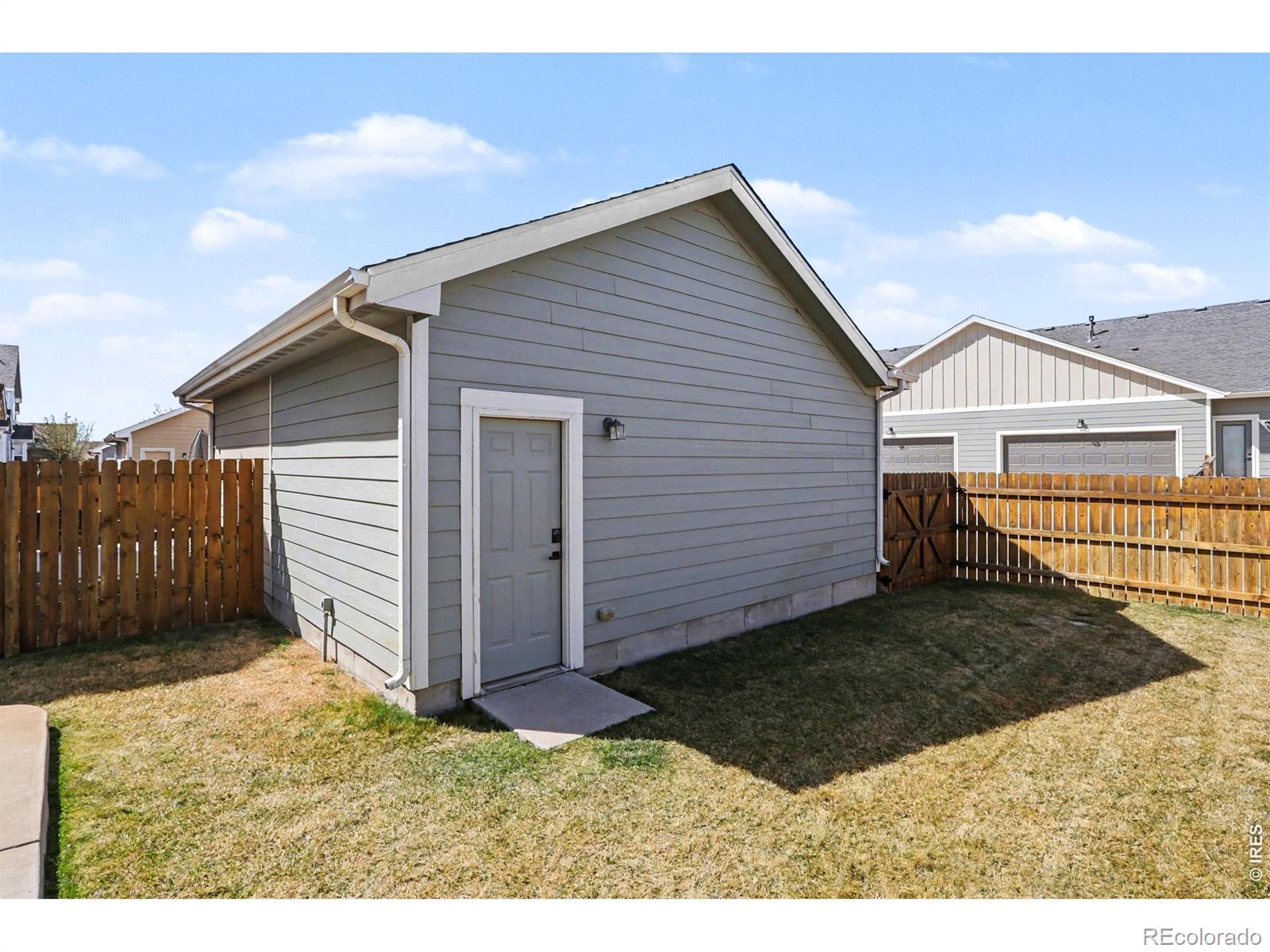 Image 4: Second garage- paired structure garage in backyard for extra storage, parking, and all the toys!