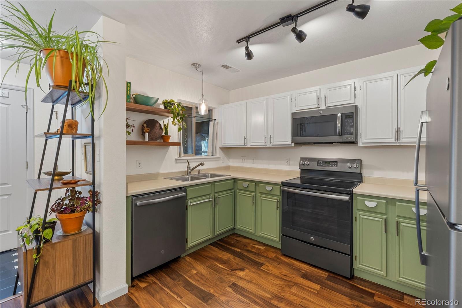 Image 2: Freshly painted oak cabinetry adds a clean, modern feel while preserving the quality of the original upgraded finishes.
