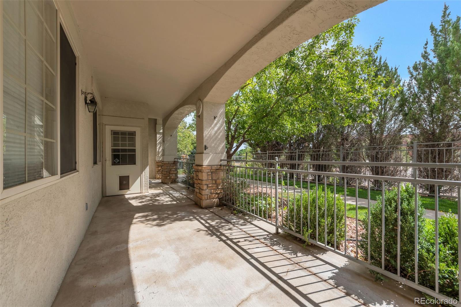 Image 3: Large covered patio, perfect for relaxing and entertaining! Door enters into the living area