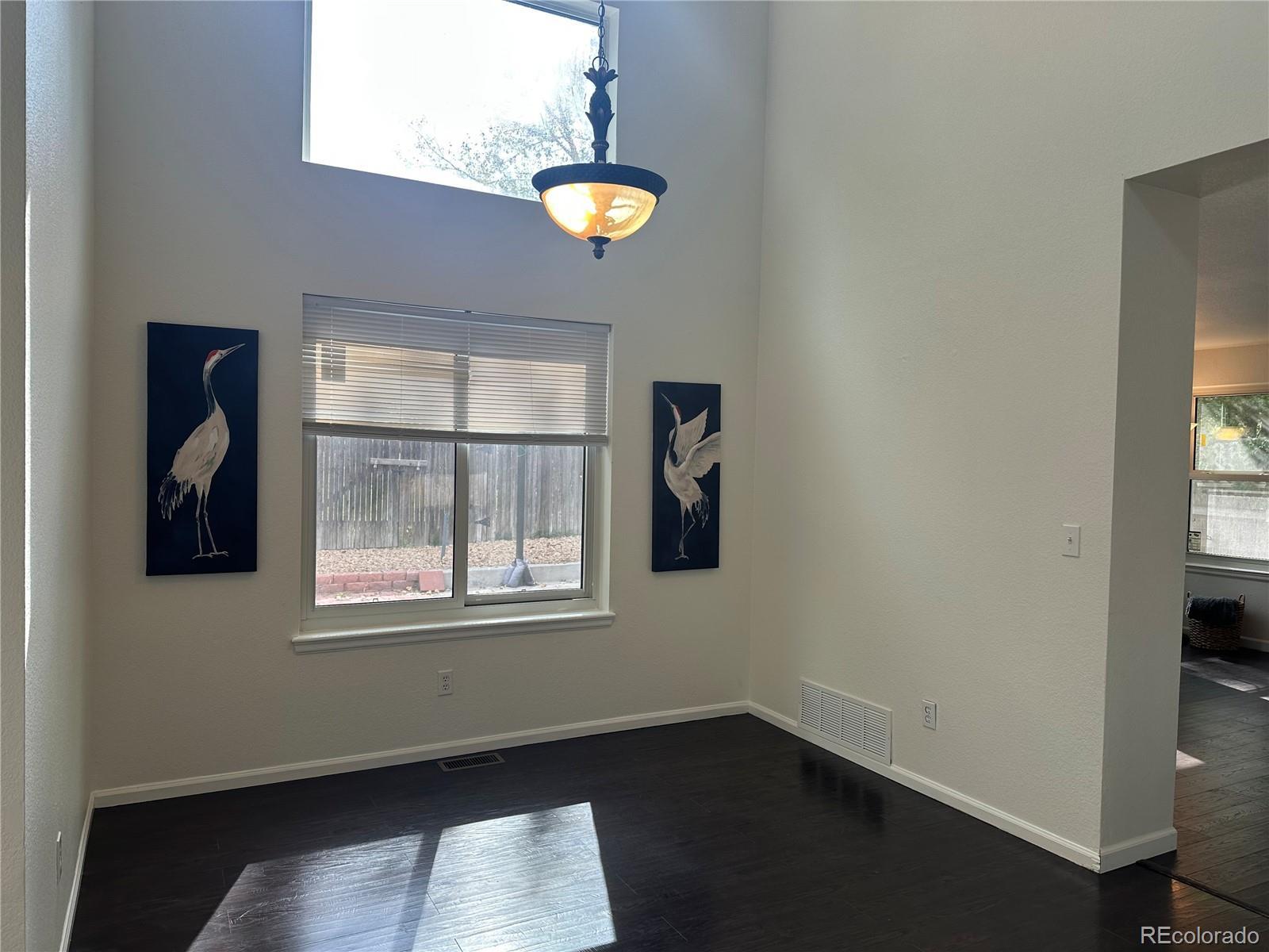 Image 4: Dining room with 2-story ceiling and new paint