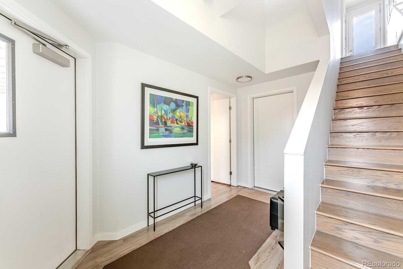 Image 2: Open the door to feel a true sense of arrival. The formal foyer offers a quiet pause between the energy of city life and the calm sophistication within.
