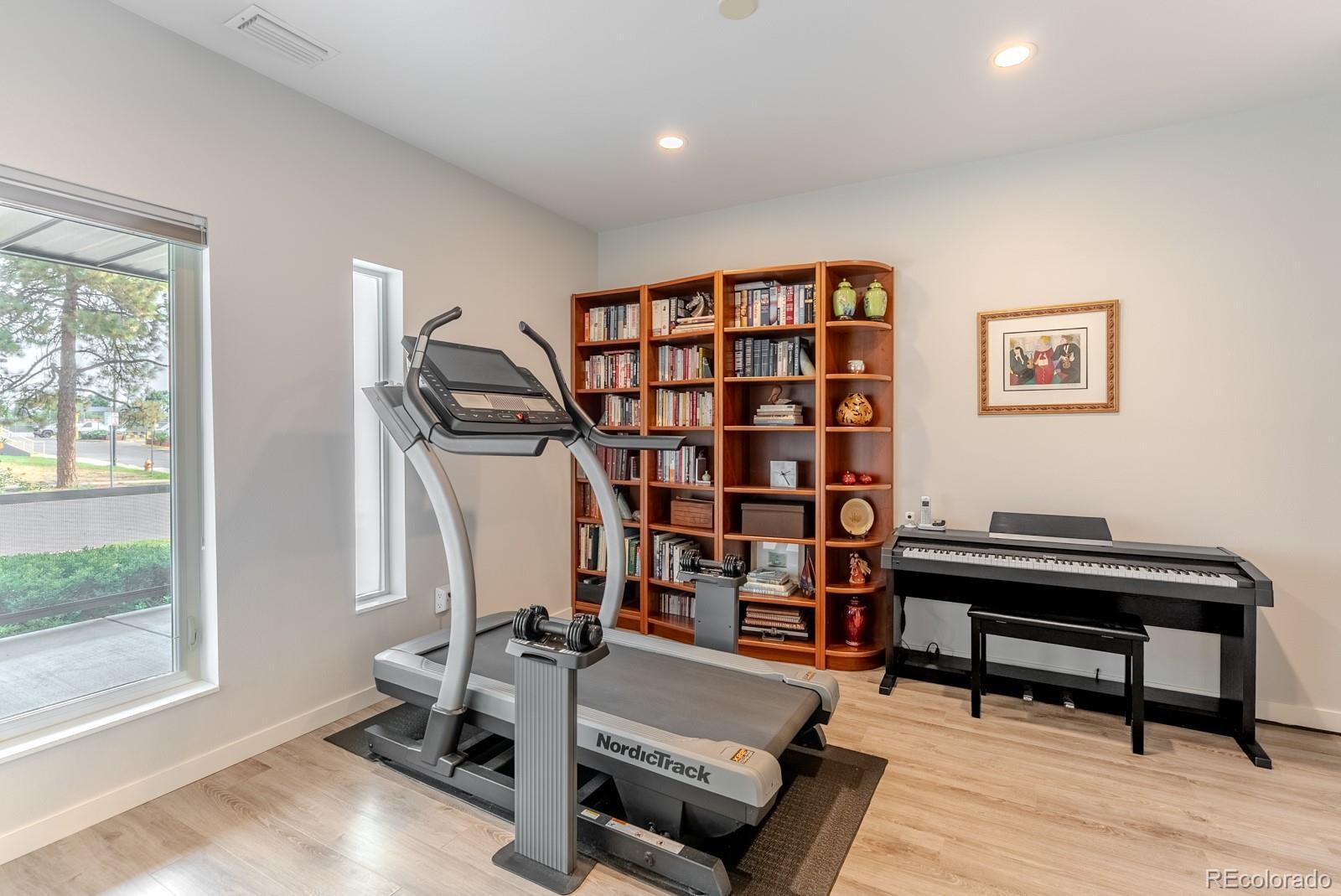 Image 4: Tucked on the entry floor, a private ADA compliant suite offers exceptional flexibility. Framed by generous windows, it&rsquo;s an ideal space for overnight guests, a serene home office, or an inspiring fitness studio.