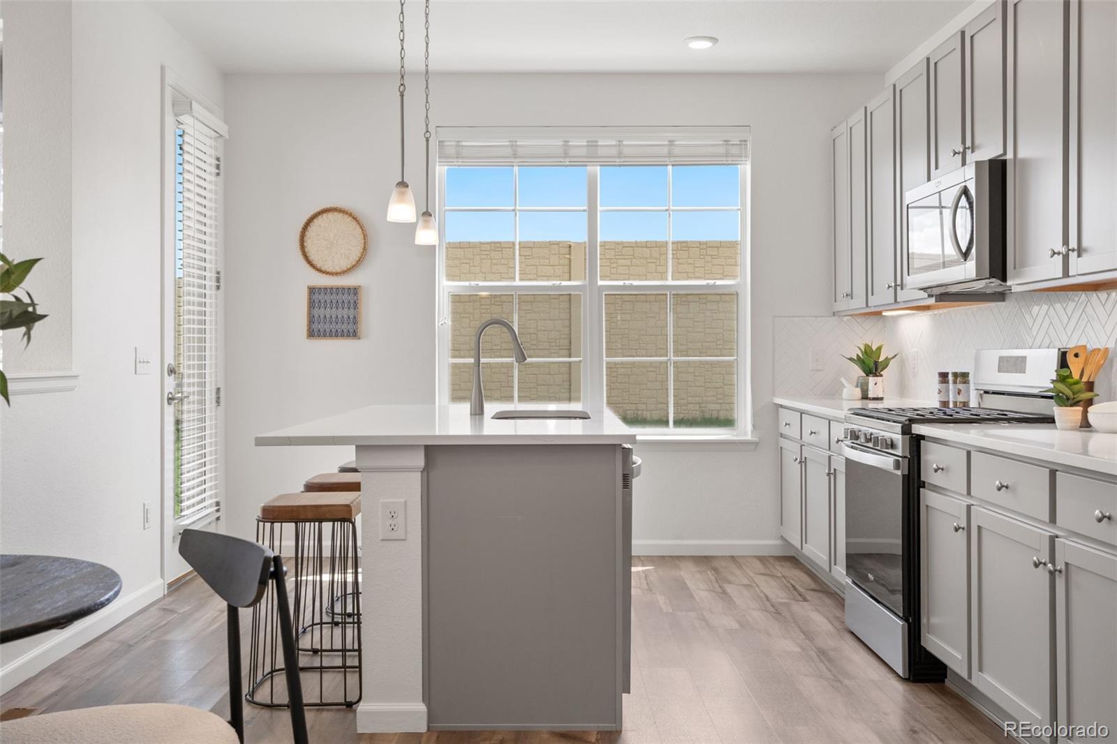 Image 4: Main Level open-concept dining area + kitchen