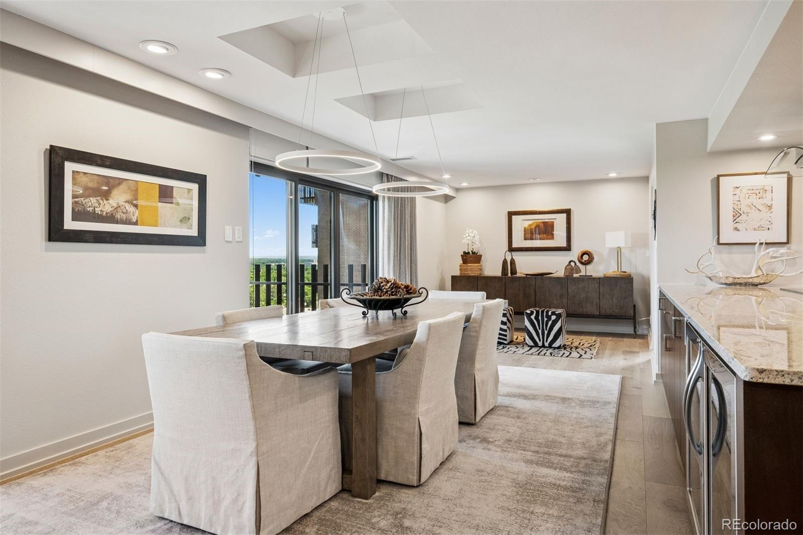 Image 4: with sliding doors to a Dining area has access to a balcony with city and park views.