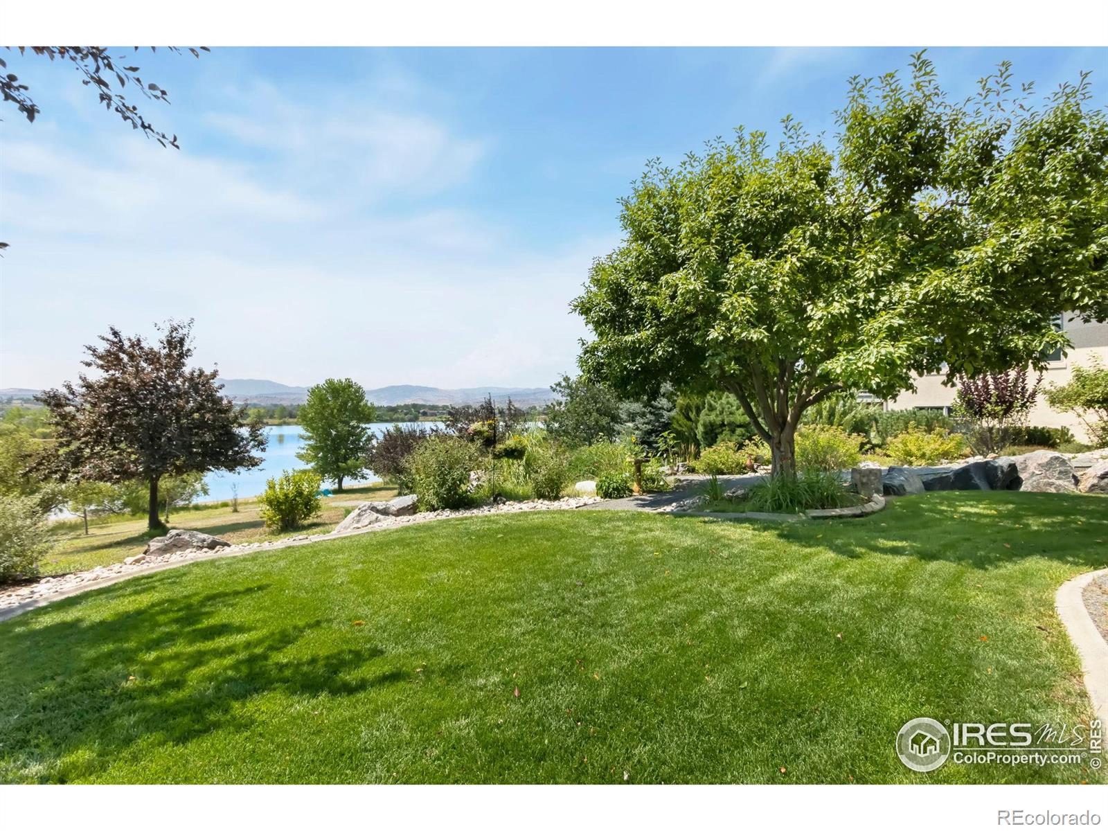 Image 2: Lush Landscaping and View of Lake & Mountains