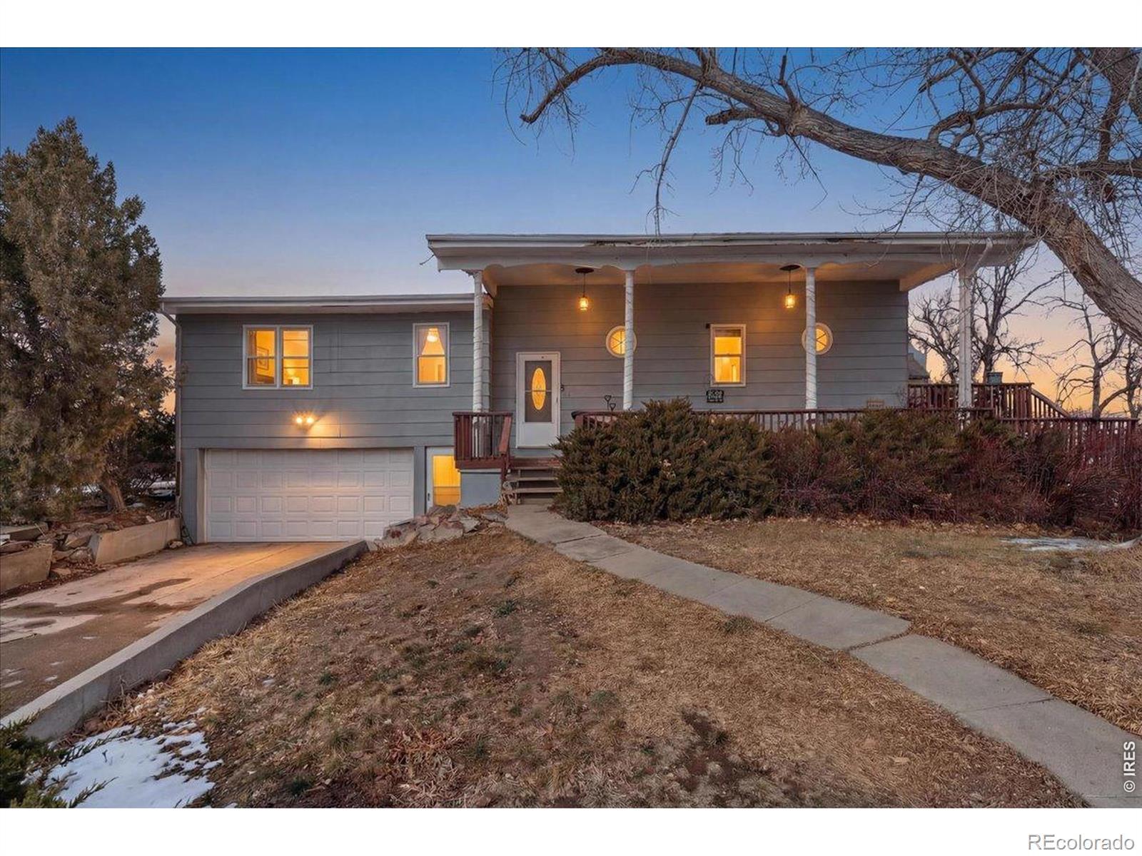 Image 2: Welcome home to 734 Victoria Drive, where the front porch invites you to grab a seat and enjoy the view.