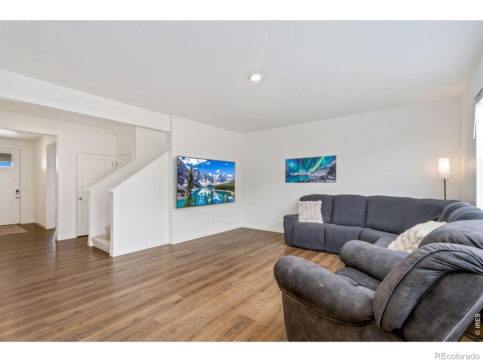 Image 4: Step inside to an open, inviting floor plan where the expansive kitchen flows seamlessly into the dining area and main living space, perfect for entertaining!